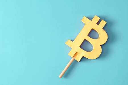 Bitcoin like ice cream on a stick minimal creative concept of profit and loss or success and risk in the cryptocurrency market with blockchain technology.の写真素材
