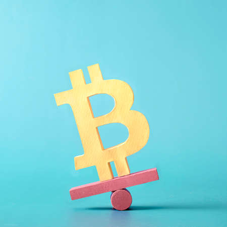 Bitcoin finance crypto money and virtual internet currency balances on a plane. Minimal trend creative concept of problems and success and loss and profit.の写真素材