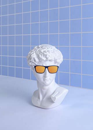 Vaporwave and synthwave minimal concept David statue head and collage with mouse cursor and circle on purple background.の写真素材