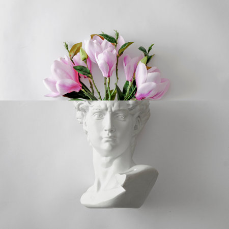 Davids statue bust of Michelangelo and a bouquet of flowers like a brain. Minimal playful concept of spring gift and creativity and art. High quality photoの写真素材