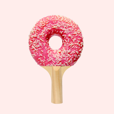 Playful collage with delicious pink donut and racket table tennis. Minimal crazy creative idea. High quality photoの写真素材