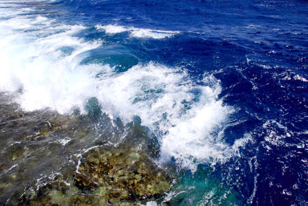 A photo was done at Sharm el Sheikh on 08.04.2009. Beautiful waves come across a coral reef, and break against him in the distance about 200 meters from a bank. の写真素材