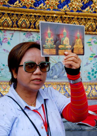 This photho was taken in Royal Palace, Bangkok on 09.02.2011. Wonder of Thai architecture, woman guide before sightseeing.のeditorial素材