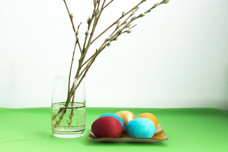Composition with Easter eggs and pussy-willow twigs on light background.の写真素材