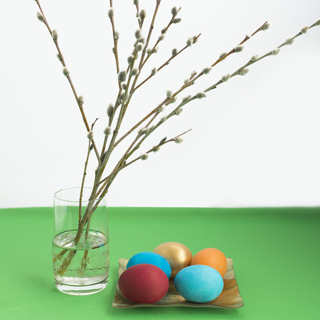 Easter composition with Easter eggs and pussy-willow branches on a white background.の写真素材