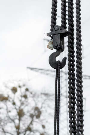 Hoist chain construction, industry crane hook, iron lift equipment, industrial manufacturing detail....