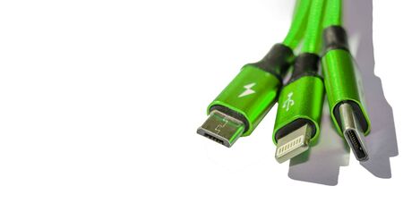 three cord charger to a green smartphone isolate on white backgroundの写真素材