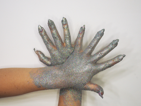 Hand with sequins isolated at whiteの写真素材