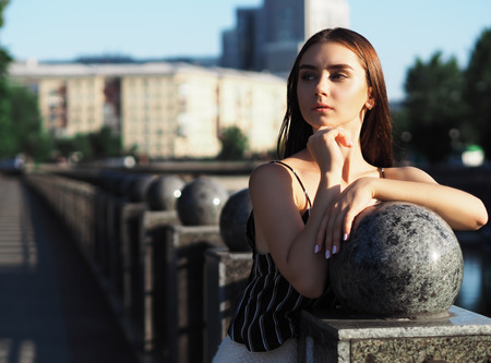 Young girl model posing at the park near the riverの写真素材