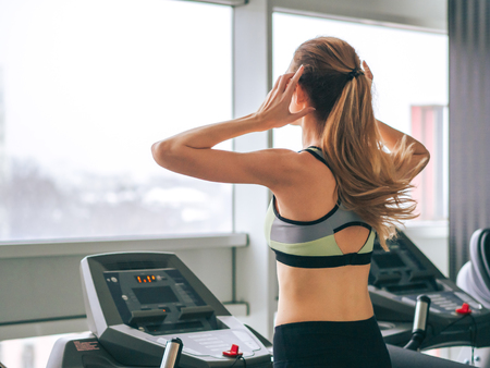 Young girl makes exercises at the gym