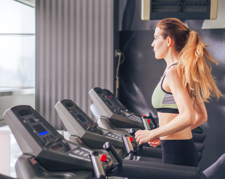 Young girl makes exercises at the gymの写真素材