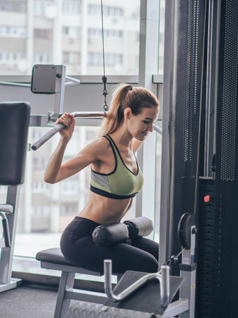 Young girl makes exercises at the gym