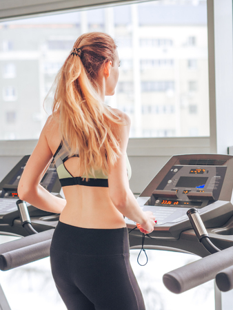 Young girl makes exercises at the gymの写真素材