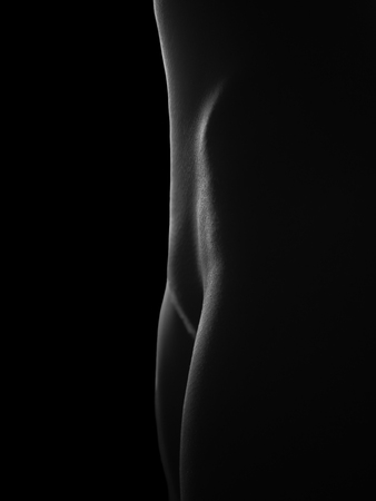 Nude female legs   isolated at blackの写真素材