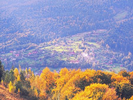 Carpatian village at mountains at the sunny dayの写真素材
