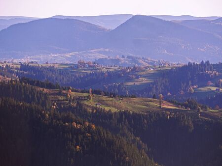 Carpatian village at mountains at the sunny dayの写真素材