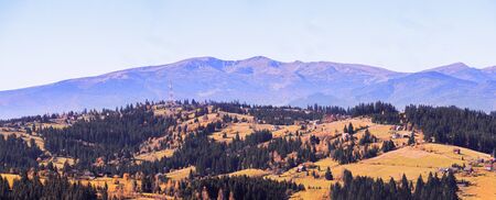 Carpatian village at mountains at the sunny dayの写真素材