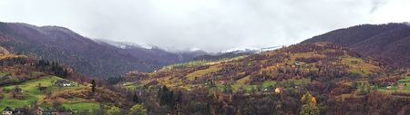 Carpatian village at mountains at the sunny dayの写真素材