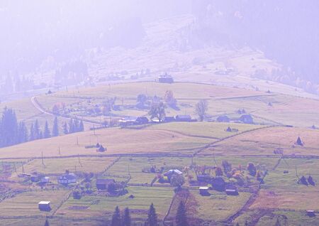 Carpatian village at mountains at the sunny dayの写真素材