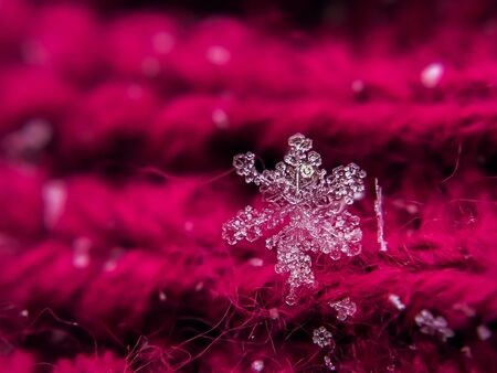 Snowflake beautiful on the red winter backgroundの写真素材
