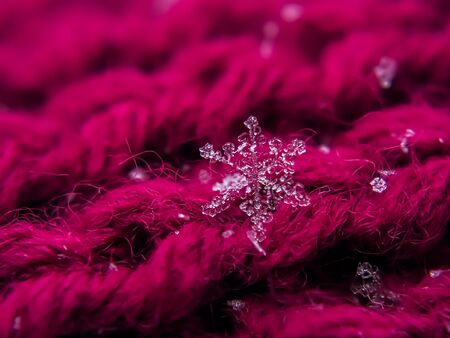 Snowflake beautiful on the red winter backgroundの写真素材