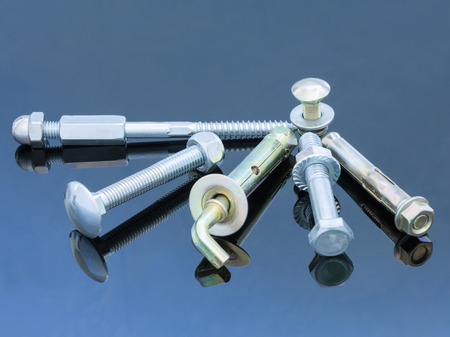 Screwbolts screw nuts, hanger and bolt washers on blue background construction concept.