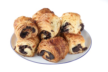 Sweet rolls with poppy seeds on a white porcelain plateの写真素材
