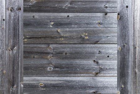 A frame in the form of a weathered old gray wooden fence, which is knocked down by wooden nails,...