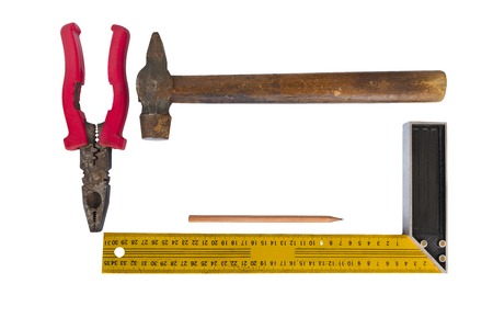 Old tools are a hammer with a wooden handle, pliers, square and pencil. Objects are isolated on a white background closeupの写真素材