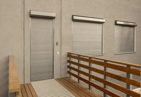Light brown metal blinds on the doors and windows of the houseの写真素材