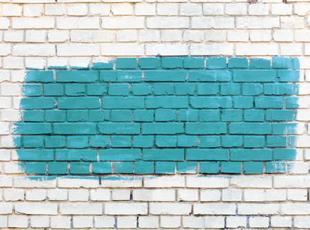 The old walls are painted with white paint and the selected fragment is painted with green paint.の写真素材