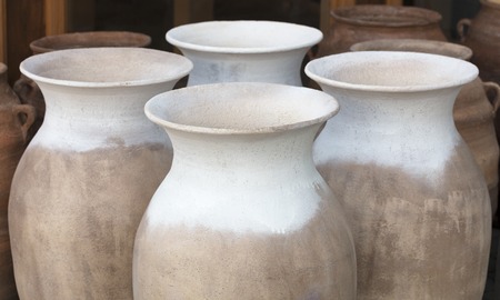 Large clay amphorae for water storage stand in a row for saleの写真素材