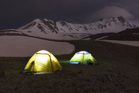 The night before the ascent - the tents of tourists shine at the foot of Erciyes Dag in central Anatolia, Turkey.の写真素材