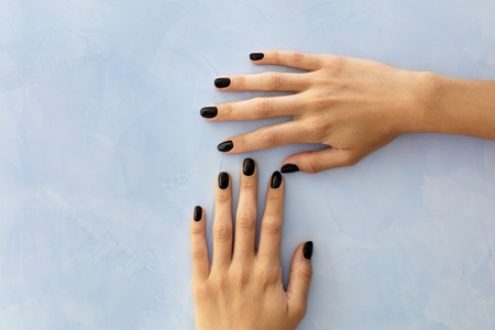 Beautiful woman's nails with beautiful manicure handsome black with glitterの写真素材