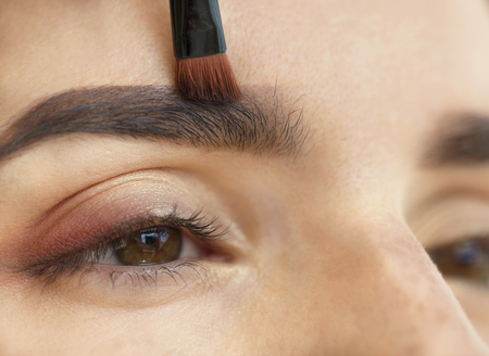 Makeup eyebrows close-up with a soft brush.の写真素材