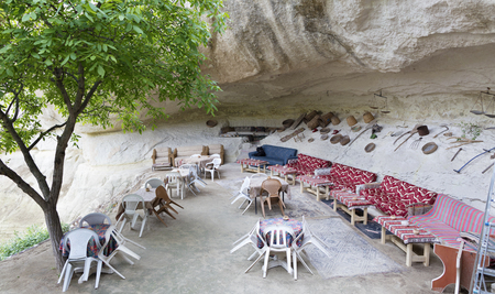A welcoming view of an old cafe in a high-rise Turkish courtyard in Cappadociaの写真素材