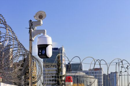 Security perimeter. Barbed wire fencing, a red light and cameras protect against intrusions against...