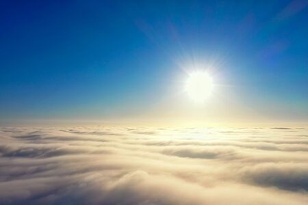 Aerial photos, bright sun over a cover of gray clouds in blure, photo about 500 meters of height...