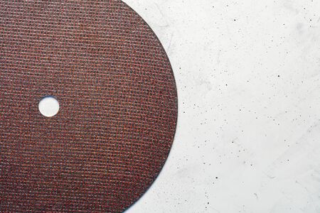 Segment semicircle of abrasive disc on a background of gray concrete close-up, image with copy space.の写真素材