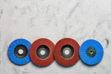 Set of grinding abrasive emery discs for grinding of the metal, wood and stone on the gray concrete background, close-up, image with copy space.の写真素材