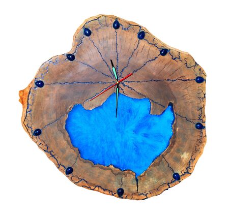 Beautiful wooden wall clock made of cut tree roots and translucent blue epoxy on the dial in the form of a clean lake, isolated on white background.の写真素材