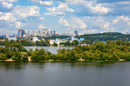 Cityscape of the right bank of Kiev with the Dnieper river and islands in the foreground and a view...