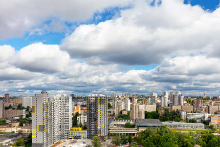 An urban landscape with high and low architecture under a beautiful dramatic sky with dense thick...