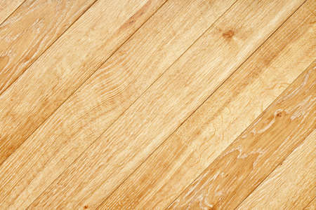 A beautiful pattern of light oak wood in the form of a smooth wooden surface with diagonal grain lines.の写真素材