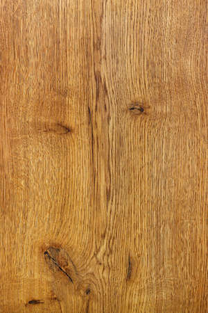 A beautiful and expressive grain of oak wood in the form of a smooth wooden surface. Vertical image.の写真素材