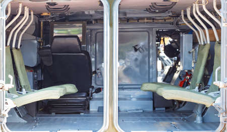 Minimalistic, rigid interior of the interior of an infantry fighting vehicle, armored personnel carrier. Selective focus, copy space.の写真素材