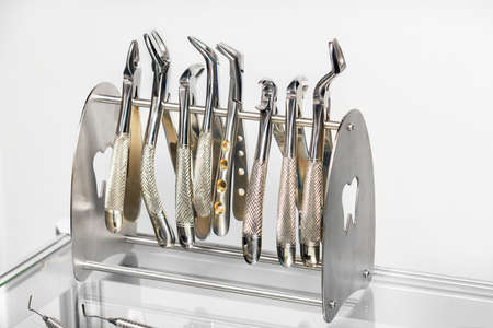 Close-up of a set of various instruments, stainless steel forceps in a dental clinic. Dentistry, orthodontics and medical instruments concept.の写真素材