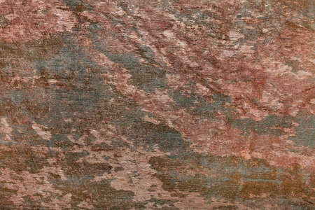 The mottled texture of stucco in browns and greens as part of a classic design.
