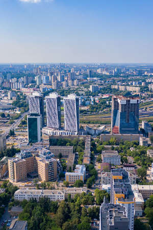 Aerial photography of residential areas of Kyiv with a view of residential areas, green parks and new skyscrapers under construction, city photography. Vertical image. Copy space.の写真素材