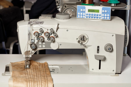 Modern sewing machine for sewing clothes with programmable mechanisms and forms of thread tension....